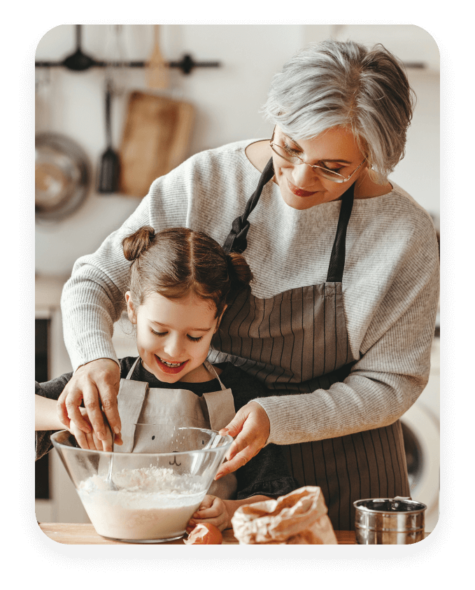 Grandmother cooking with granddaughter.